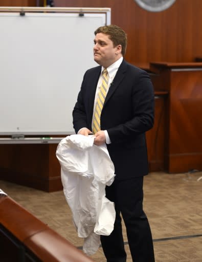 Attorney Brent Wisner displays a protective suit like the one worn by his client, the plaintiff Dewayne Johnson, who is suing Monsanto alleging its weed killer Roundup caused his cancer