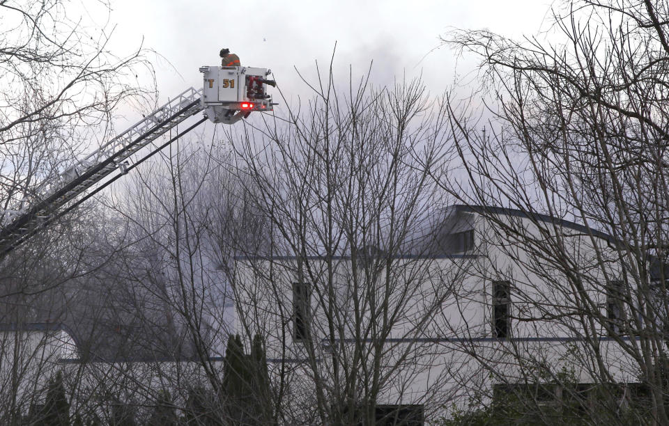 FILE - In this Nov. 20, 2018 file photo, firefighters work the scene of a fatal fire in Colts Neck,N.J. The bodies of Keith Caneiro, his wife Jennifer Caneiro, and their children Jesse, 11, and Sophia 8, were found at the scene: all victims of an apparent homicide. (AP Photo/Noah K. Murray, File)