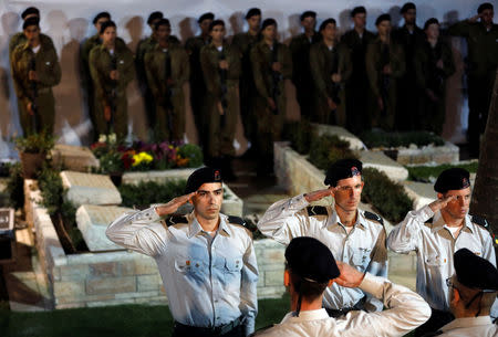 People attend the funeral of Zachary Baumel, a U.S.-born Israeli soldier missing since a 1982 tank battle against Syrian forces and whose remains were recently recovered by Israel, at the Mount Herzl military cemetery in Jerusalem April 4, 2019. REUTERS/Ronen Zvulun