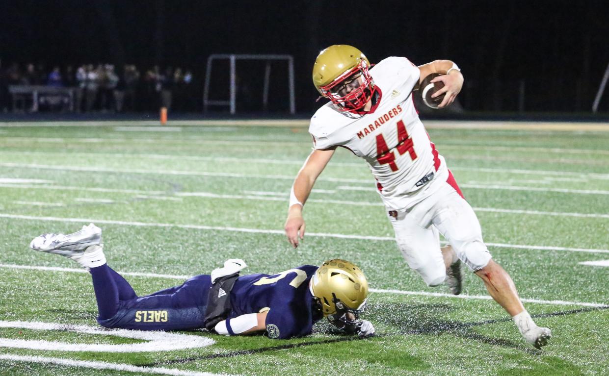 Roxbury's Jared Irwin defends as Mount Olive's Tyler Cumming runs the ball during the first half of the North 2, Group 4 sectional final at Roxbury High School on November 10, 2023.