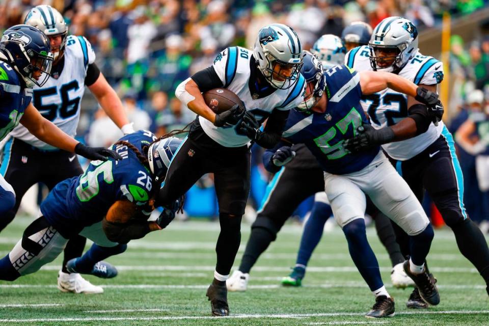 Dec 11, 2022; Seattle, Washington, USA; Carolina Panthers running back Chuba Hubbard (30) rushes against the Seattle Seahawks during the second quarter at Lumen Field. Mandatory Credit: Joe Nicholson-USA TODAY Sports