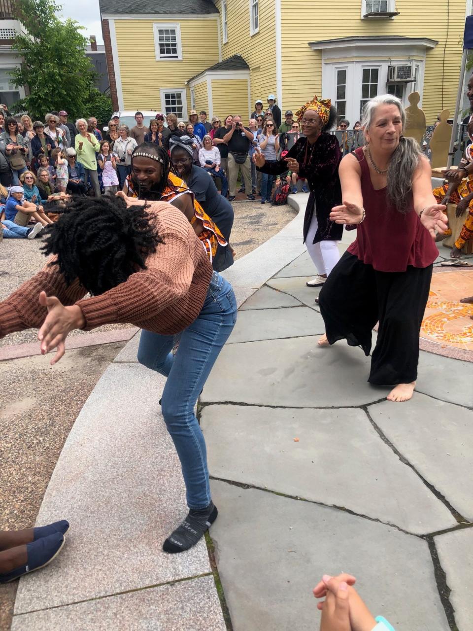 Crowd members join the dancing with the Akwaaba Ensemble drumming performance during a Juneteenth ceremony Monday, June 19, 2023 at the African Burying Ground in Portsmouth.