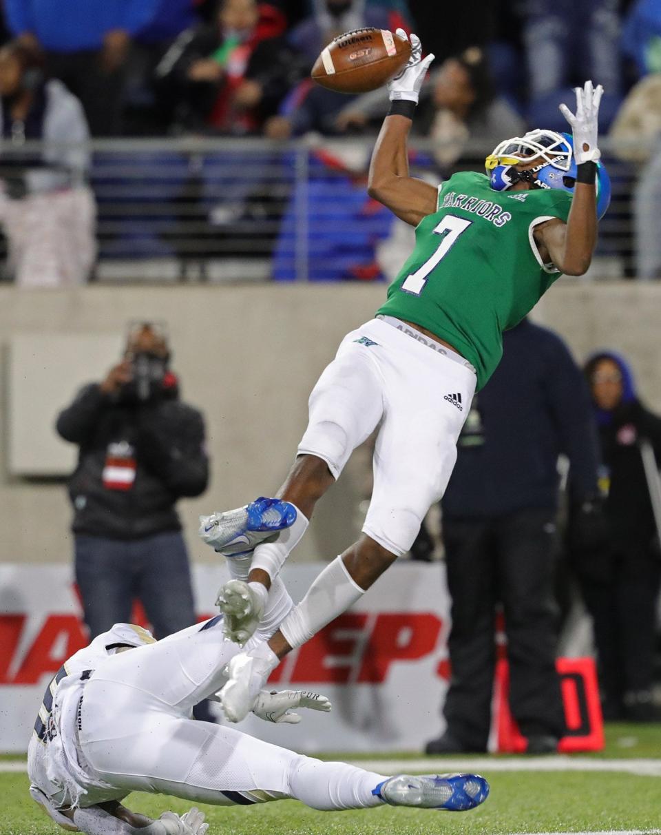 Cincinnati Winton Woods defensive back Jermaine Mathews Jr. nearly picks off a pass intended for Hoban receiver Rickey Williams, bottom, during the first half of the OHSAA Division II state title game at Tom Benson Hall of Fame Stadium, Thursday, Dec. 2, 2021, in Canton, Ohio.