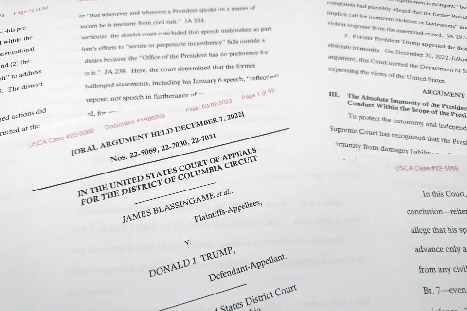 A federal court filing from the Justice Department is photographed Thursday, March 2, 2023. Former President Donald Trump can be sued by injured U.S. Capitol Police officers and Democratic lawmakers over the Jan. 6, 2021, insurrection at the U.S. Capitol, the Justice Department said in a federal court case testing Trump's legal vulnerability and the limits of executive power. (AP Photo/Jon Elswick)