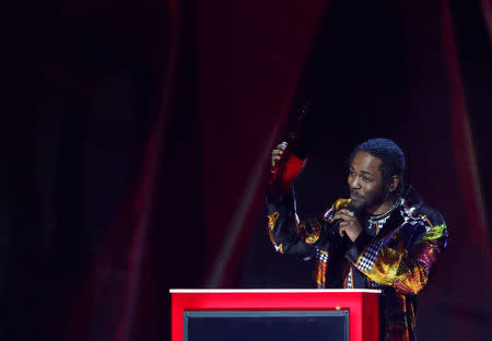 Kendrick Lamar accepts the award for international solo male artist at the Brit Awards at the O2 Arena in London, Britain, February 21, 2018. REUTERS/Hannah McKay