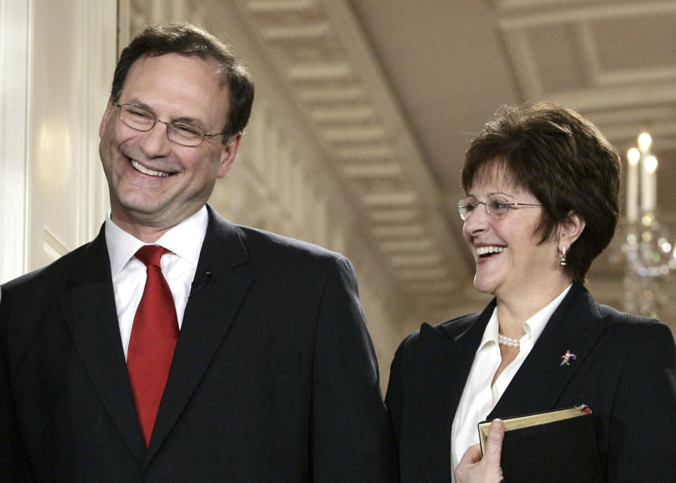FILE - Supreme Court Justice Samuel Alito, left, and Martha-Ann Alito attend his ceremonial swearing-in at the White House Feb. 1, 2006, in Washington. An upside-down American flag was displayed outside of Alito's home Jan. 17, 2021, days after former President Donald Trump supporters stormed the U.S. Capitol, The New York Times reports. It's a symbol associated with Trump's false claims of election fraud. "It was briefly placed by Mrs. Alito in response to a neighbor's use of objectionable and personally insulting language on yard signs," Alito said in an emailed statement to the newspaper. (AP Photo/Charles Dharapak, File)