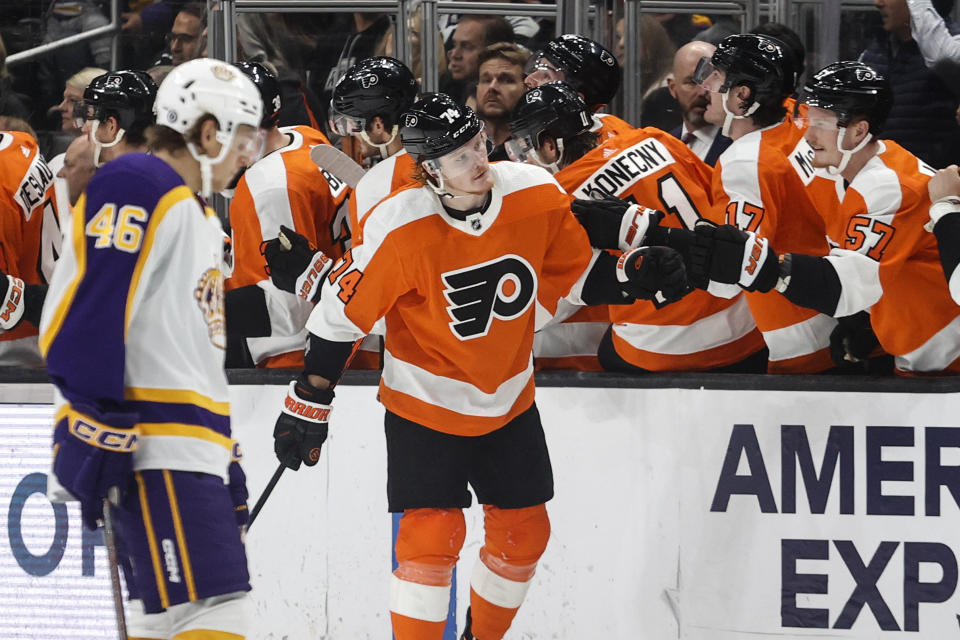 Philadelphia Flyers forward Owen Tippett, center, is congratulated for his goal during the second period of an NHL hockey game against the Los Angeles Kings Saturday, Dec. 31, 2022, in Los Angeles. (AP Photo/Ringo H.W. Chiu)