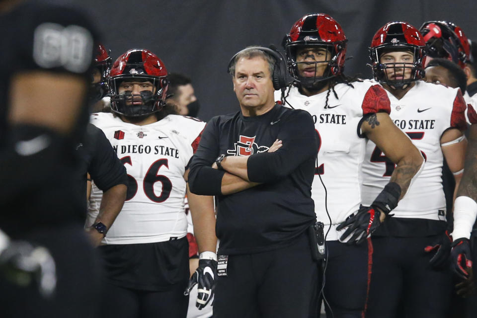 San Diego State head coach Brady Hoke looks on during the first half of an NCAA college football game against UNLV on Nov. 19, 2021, in Las Vegas. The No. 19 San Diego State Aztecs have called the Los Angeles suburbs their home for two seasons while they're building a new stadium in Mission Valley. They'll host Utah State in the Mountain West Conference championship game Saturday in Carson. (AP Photo/Chase Stevens)