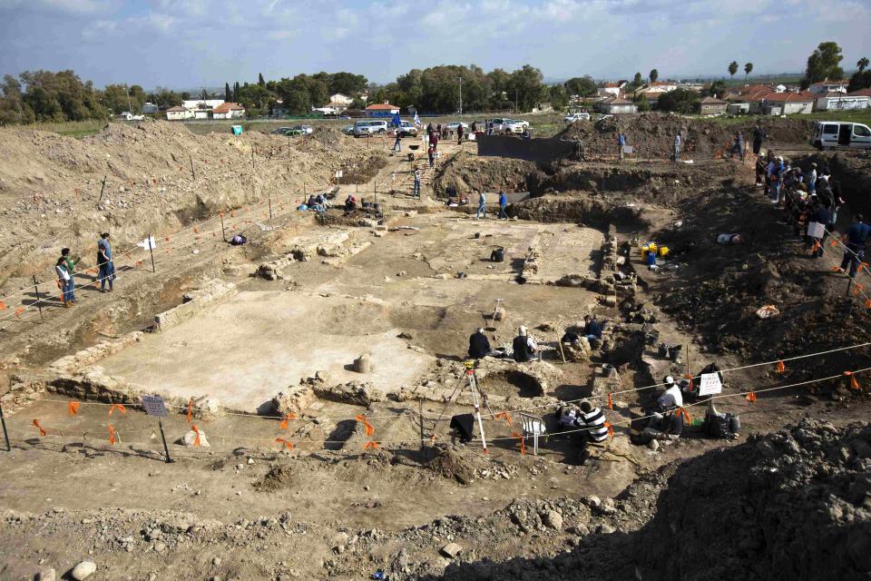 Civilians stand near a cordoned-off excavation site where a mosaic floor of an ancient Byzantine church was uncovered near Kiryat Gat