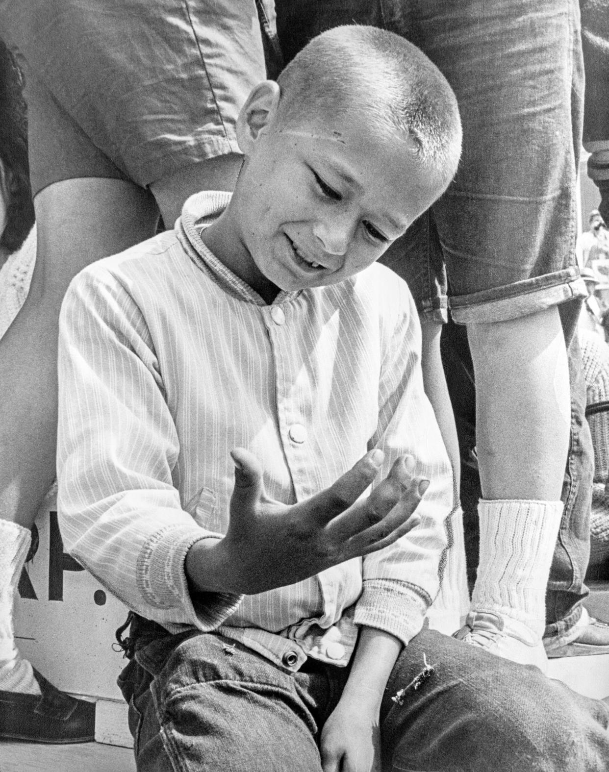 Michael Howlett, 10, examines his hand in disbelief after shaking hands with President Lyndon B. Johnson at Worcester Airport on June 10, 1964. The photo appeared in the next day's Worcester Telegram.