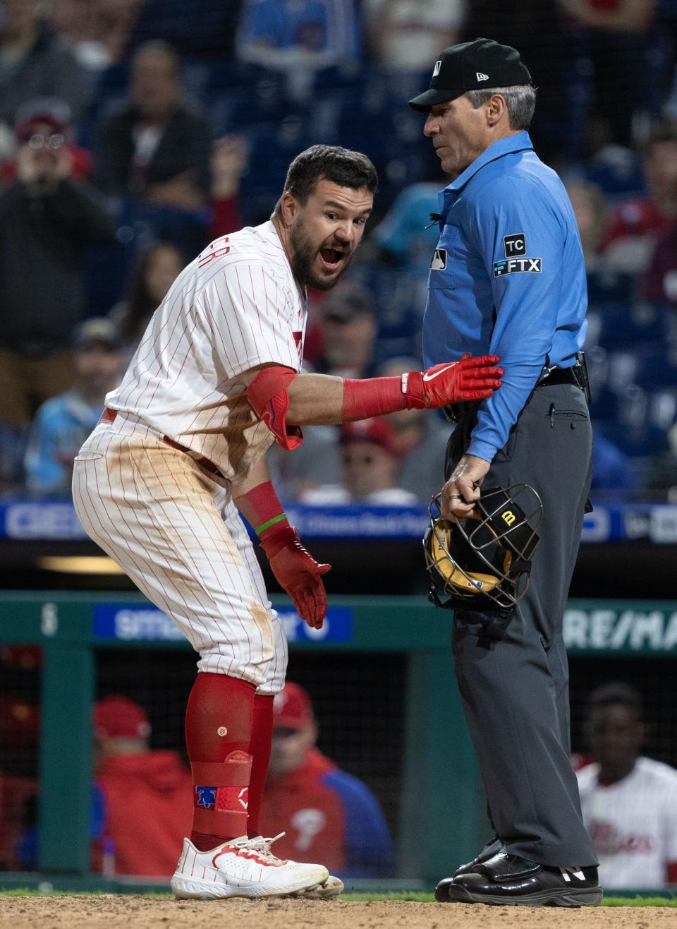 Philadelphia Phillies designated hitter Kyle Schwarber argues with umpire Angel Hernandez after being called out on strikes during the ninth inning against the Milwaukee Brewers at Citizens Bank Park.