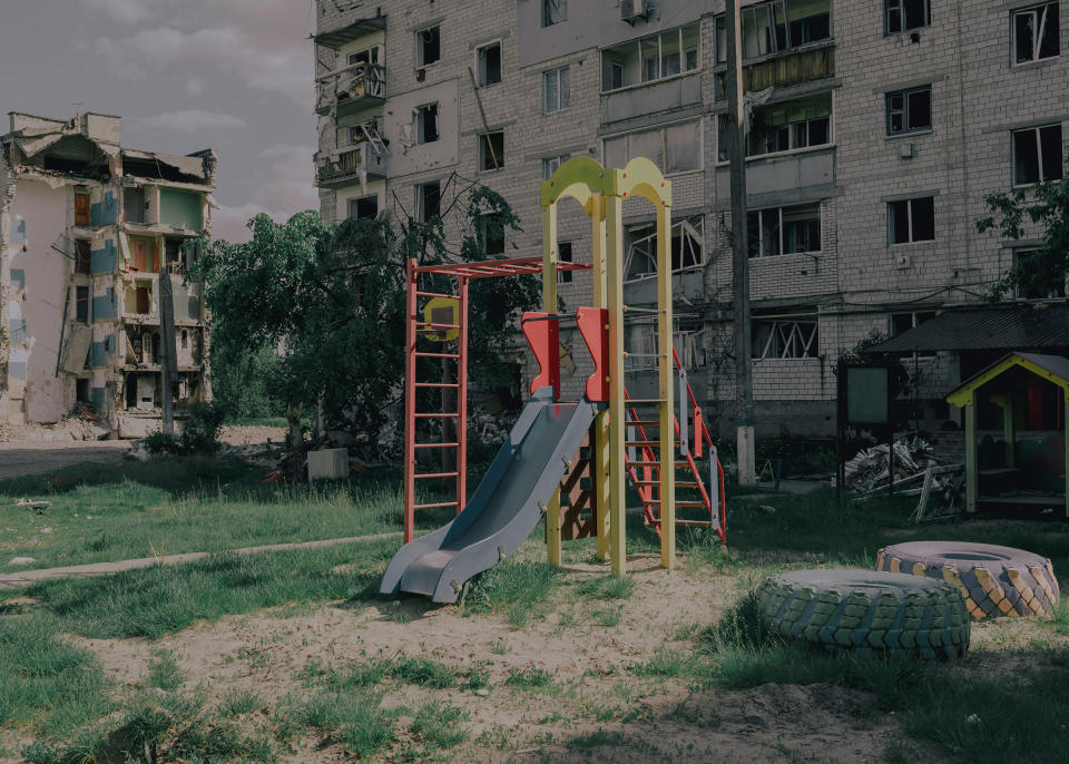 A play structure behind several destroyed buildings is still used by children.<span class="copyright">Fabian Ritter—DOCKS Collective</span>