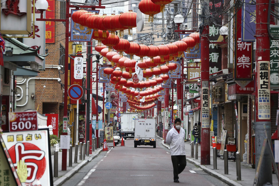 A man wearing face mask as a safety precaution against the new coronavirus walks at empty China Town in Yokohama, near Tokyo, Tuesday, March 31, 2020. The United Nations Secretary-General Antonio Guterres on Tuesday, Aug. 25, 2020, said the global tourism industry has been devastated by the coronavirus pandemic, with $320 billion lost in exports in the first five months of the year and more than 120 million jobs at risk. (AP Photo/Koji Sasahara, File)