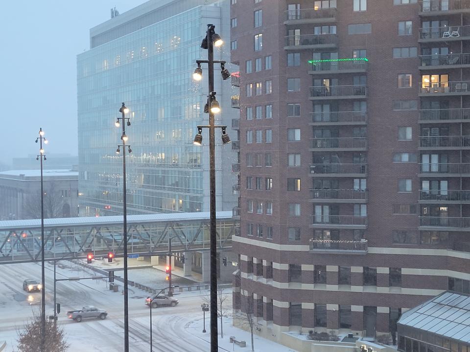 Snow falls in downtown Des Moines as a blizzard approaches.