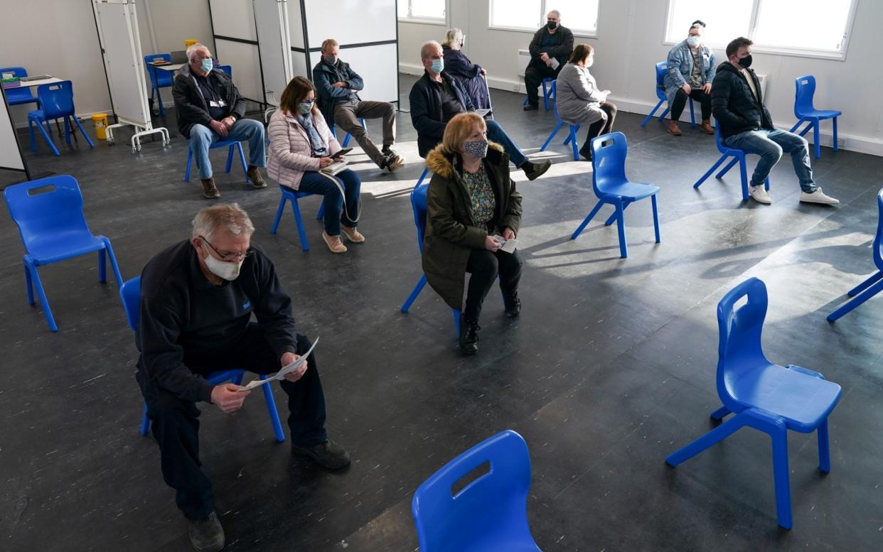 Patients wait in a post-vaccine observation area after receiving the AstraZeneca vaccine - Getty