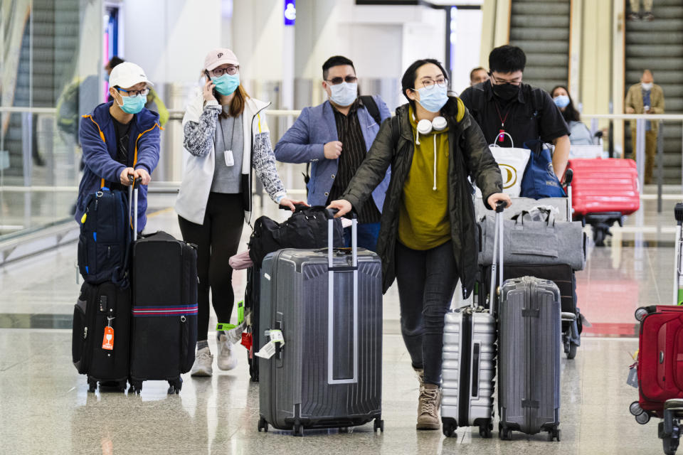  Passengers wear protective masks amid Coronavirus threats at the Hong Kong International Airport. In response to the latest situations of Covid-19 Pandemic, all people who have been to all overseas countries/territories in the past 14 days prior to arrival in Hong Kong, regardless of whether they are Hong Kong residents, are required by law for compulsory self-quarantine and to wear electronic bracelets, connected to an app to mark your location for two weeks. (Photo by Keith Tsuji / SOPA Images/Sipa USA) 