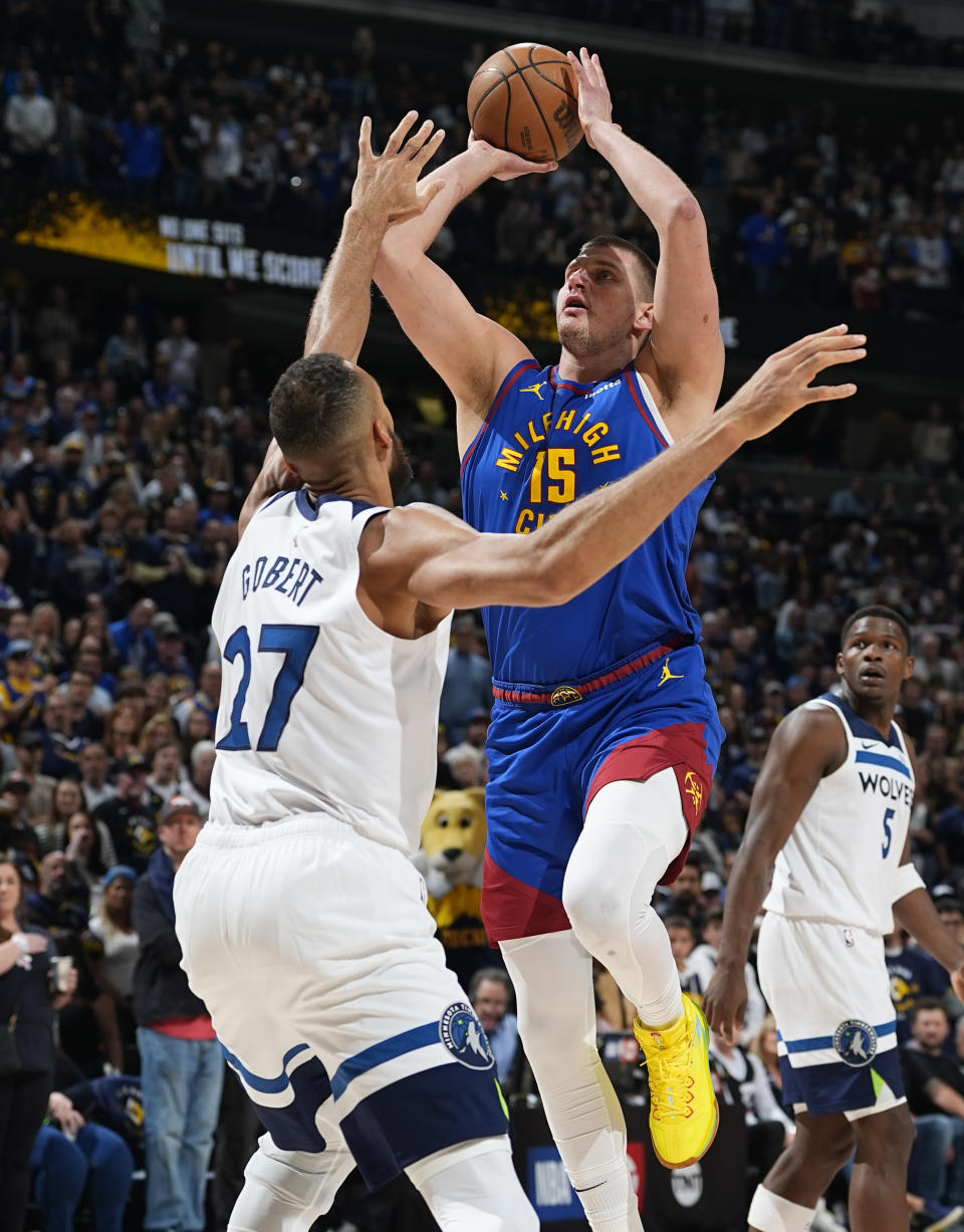 Denver Nuggets center Nikola Jokic, right, goes up for a basket over Minnesota Timberwolves center Rudy Gobert in the first half of Game 1 of an NBA basketball second-round playoff series Saturday, May 4, 2024, in Denver. (AP Photo/David Zalubowski)
