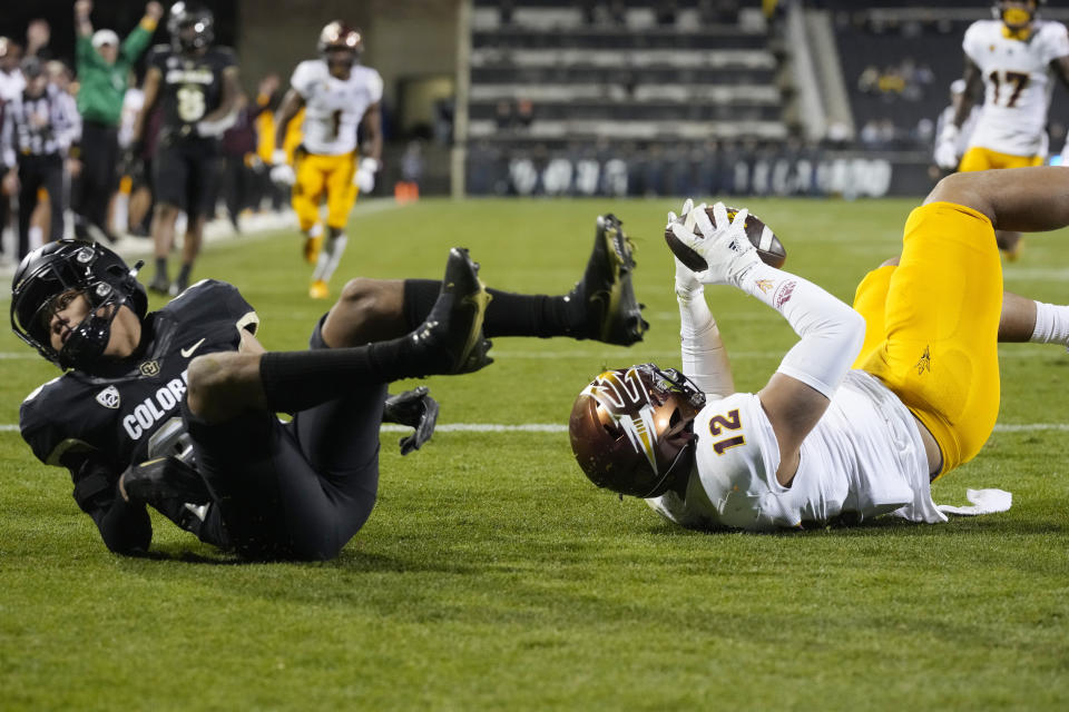 Arizona State tight end Jalin Conyers, right, tumbles into the end zone after catching a pass for a touchdown as Colorado cornerback Jason Oliver defends in the second half of an NCAA college football game Saturday, Oct. 29, 2022, in Boulder, Colo. (AP Photo/David Zalubowski)