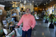 Martin Garcia, owner of gift and décor store Gramercy Gift Gallery, poses for a photo at his shop, Wednesday, June 29, 2022, in San Antonio. Landlords were forgiving about rent during the first two years of the pandemic, but now many are asking for back due rent. Meanwhile, most of the government aid programs that helped small businesses get through the pandemic have ended. (AP Photo/Eric Gay)