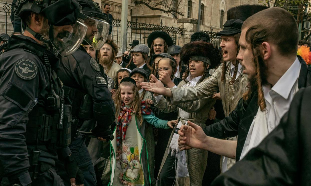 <span>Haredi families confront members of the Israel Defense Forces in Mea Shearim, the ultra-Orthodox neighbourhood in Jerusalem.</span><span>Photograph: Alessio Mamo/The Guardian</span>