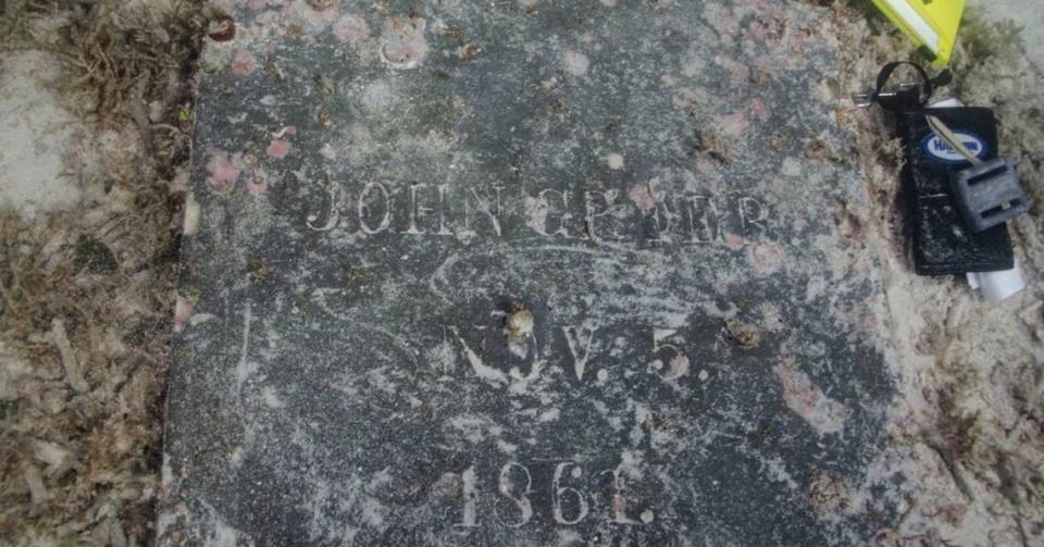 A greywacke headstone found underwater in the Dry Tortugas National Park shows the name of John Greer and his date of death.