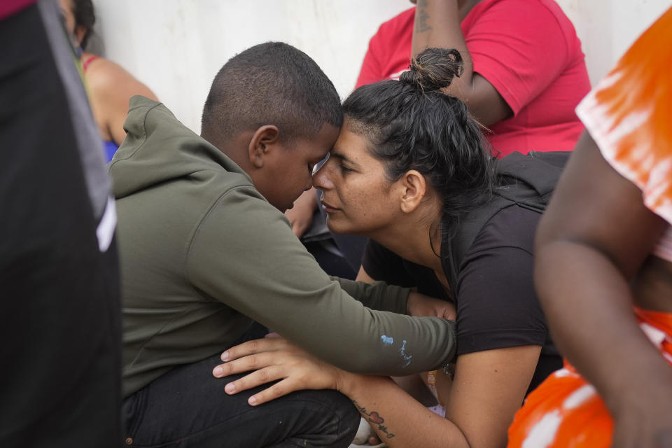 Venezuelan migrant Nelsy Zavala, right, embraces fellow Venezuelan migrant Yeikel Mojica, whom she met while crossing the Darien Gap and says was like a little brother to her, in a temporary camp in Lajas Blancas, Panama, Thursday, June 27, 2024. (AP Photo/Matias Delacroix)