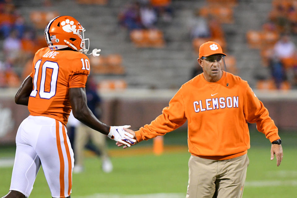 CLEMSON, SC - OCTOBER 03: Clemson Tigers head coach Dabo Swinney high fives Clemson Tigers wide receiver Joseph Ngata (10) prior to the game between the Clemson Tigers and the Virginia Cavaliers on October 03, 2020 at Memorial Stadium in Clemson, South Carolina. (Photo by Dannie Walls/Icon Sportswire via Getty Images)