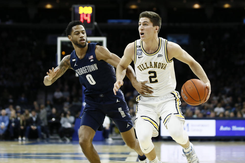 Villanova's Collin Gillespie, right, tries to dribble past Georgetown's Jahvon Blair during the first half of an NCAA college basketball game, Saturday, Jan. 11, 2020, in Philadelphia. (AP Photo/Matt Slocum)