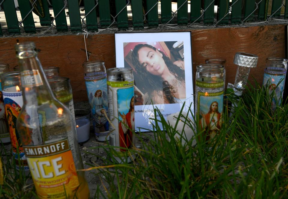 Several dozen candles flicker in the morning light around a portrait of Maribel Morales-Rosado, at a memorial in front of her home on Wednesday, Aug. 12, 2020, where she was shot multiple times by her ex-boyfriend, Donald L. Williams according to Martin County Sheriff William Snyder, on Tuesday, and died from her injuries.