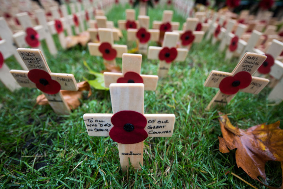 <p>Messages are written on Crosses of Remembrance placed in the Field of Remembrance at Westminster Abbey in central London on Nov. 11, 2017, the Armistice Day. On Armistice Day, many Britons wear a paper red poppy — symbolizing the poppies which grew on French and Belgian battlefields during World War I — in their lapels. (Photo: Chris J. Ratcliffe/AFP/Getty Images) </p>