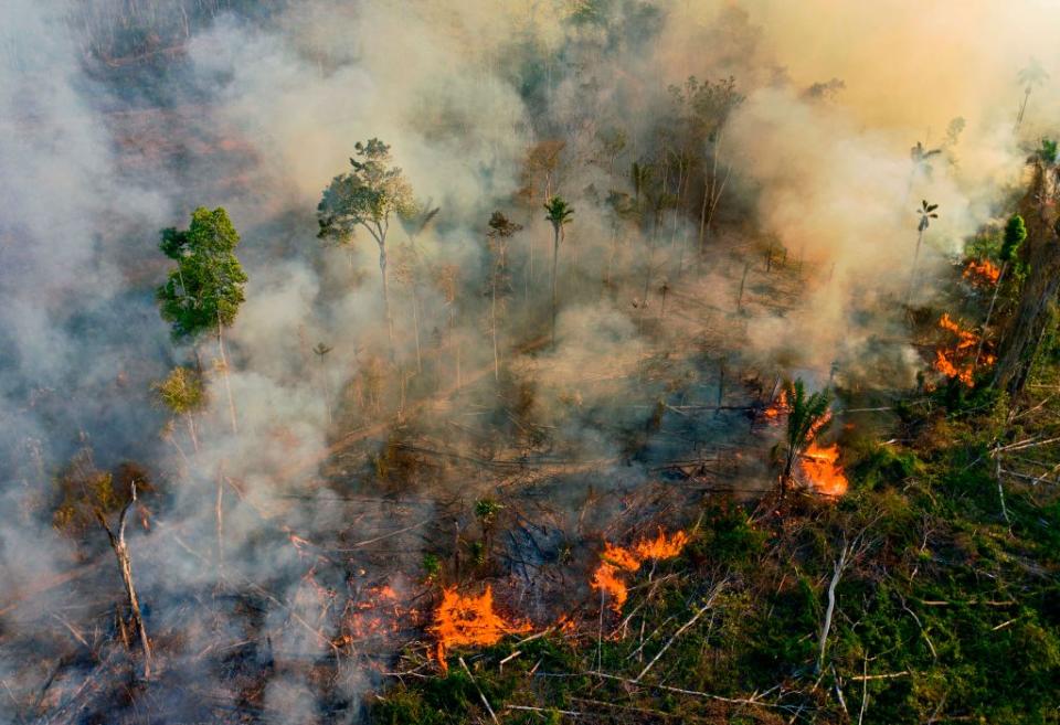 Smoke and flames rise from an illegally lit fire in Amazon rainforest reserve, south of Novo Progresso in Para state, Brazil, on Aug. 15, 2020.<span class="copyright">Carl de Souza / AFP via Getty Images</span>