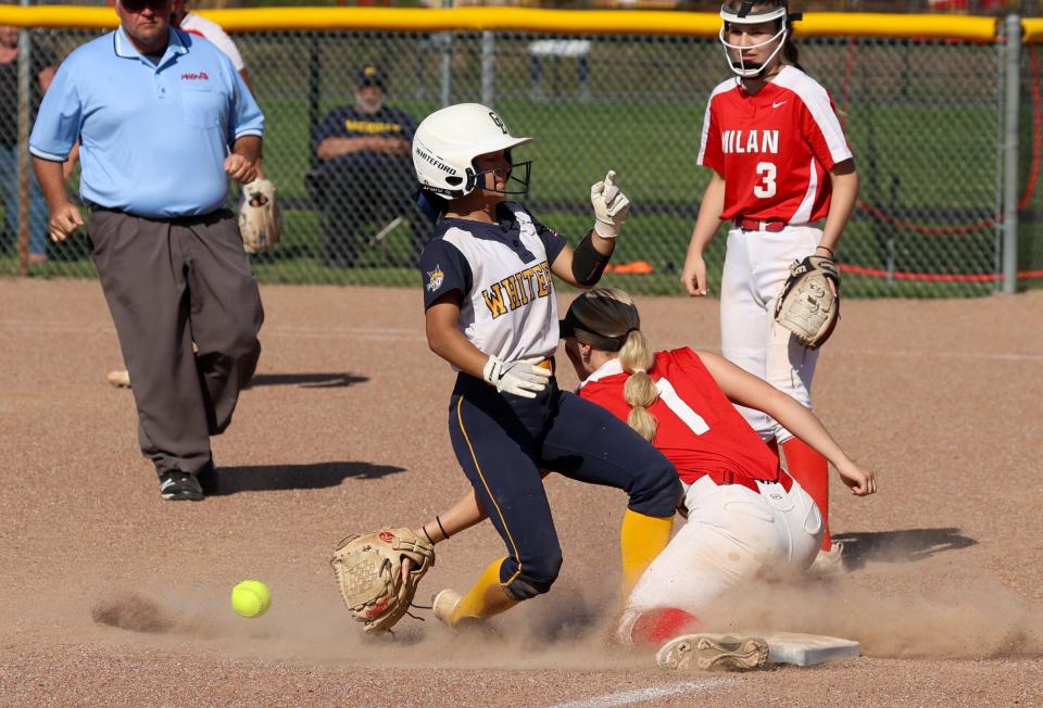 Shay Alexander of Whiteford makes it safely to third base as she gets tangled up with Hailey McCleary of Milan. Whiteford swept a doubleheader 1-0 and 8-4 Thursday.