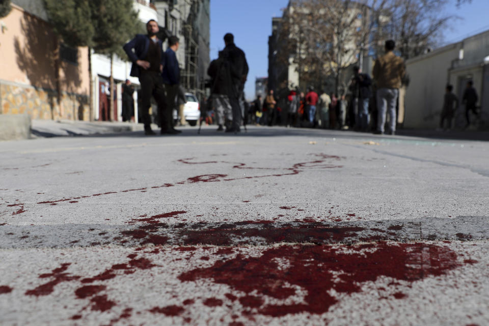 Blood stains the ground at the scene where gunmen fired in Kabul, Afghanistan, Sunday, Jan. 17, 2021. Gunmen fired on a car in northern Kabul on Sunday, killing two women judges who worked for Afghanistan's high court and wounding the driver, a court official said. It was the latest attack in the Afghan capital during peace talks between Taliban and Afghan government officials in Qatar. (AP Photo/Rahmat Gul)