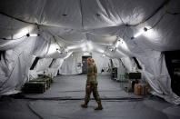 U.S. Army Captain Sisler walks in the operating suite at a military field hospital for non-coronavirus patients inside CenturyLink Field Event Center during the coronavirus disease (COVID-19) outbreak in Seattle