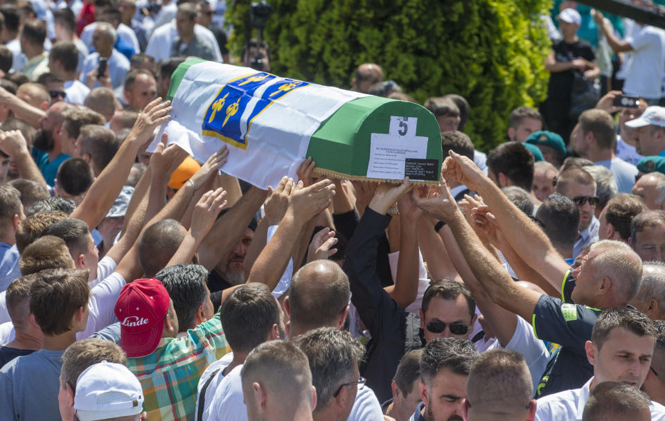 in Potocari near Srebrenica, Bosnia, Thursday, July 11, 2019. Thousands of mourners, including relatives of the victims, are gathering for a commemoration on the 24th anniversary of the Srebrenica massacre, the worst mass killing in Europe since World War II. The ceremony at a memorial site near Srebrenica included the burial of 33 newly identified victims of the July 11-22, 1995 massacre in which more than 8,000 Bosnian Muslim men and boys were killed in and around the U.N.-protected enclave by Bosnian Serb troops during the Bosnian civil war. (AP Photo/Darko Bandic)