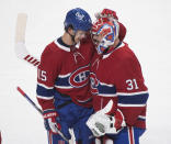 Montreal Canadiens' Jesperi Kotkaniemi (15) celebrates with Carey Price after scoring against the Toronto Maple Leafs during overtime in Game 6 of an NHL hockey Stanley Cup first-round playoff seres Saturday, May 29, 2021, in Montreal. (Graham Hughes/The Canadian Press via AP)