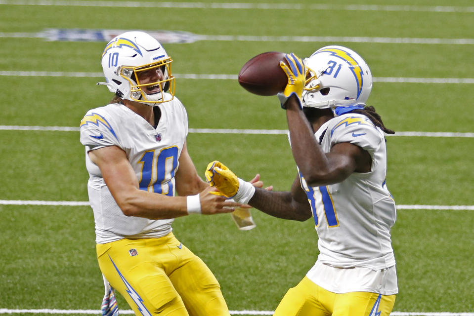 Los Angeles Chargers wide receiver Mike Williams (81) celebrates his touchdown reception with quarterback Justin Herbert (10) in the first half of an NFL football game against the New Orleans Saints in New Orleans, Monday, Oct. 12, 2020. (AP Photo/Brett Duke)