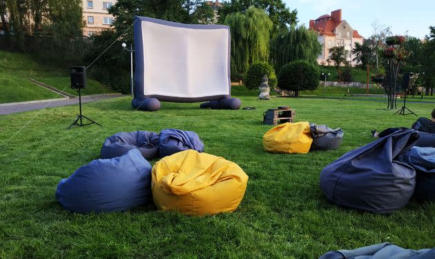 open-air cinema in the park (Photo: stanisluva via Getty Images/iStockphoto)