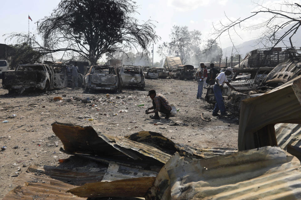 People look for salvageable items at a car mechanic shop that was set on fire during gang violence in Port-au-Prince, Haiti, Monday, March 25, 2024. (AP Photo/Odelyn Joseph)