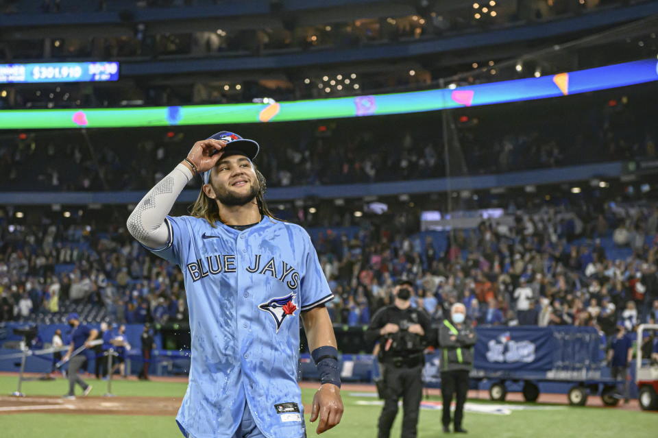 Toronto Blue Jays shortstop Bo Bichette looks on after he was doused by first baseman Vladimir Guerrero Jr. after they defeated the Houston Astros in a baseball game in Toronto, Sunday, May 1, 2022. (Christopher Katsarov/The Canadian Press via AP)