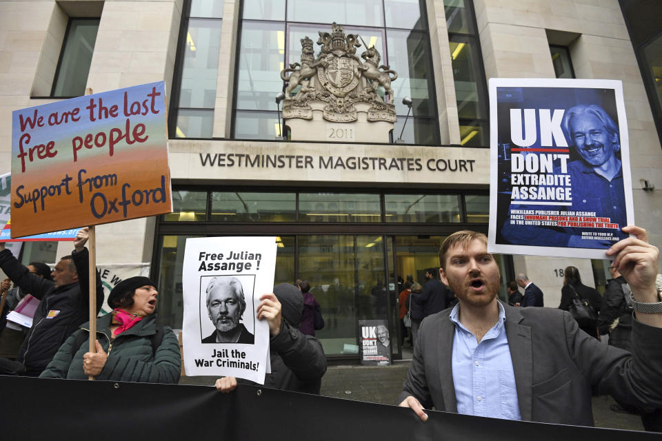 Supporters of Wikileaks founder Julian Assange demonstrate oustide Westminster Magistrates' Court in London where Assange is expected to appear as he fights extradition to the United States on charges of conspiring to hack into a Pentagon computer, in London, Monday, Oct, 21, 2019. U.S. authorities accuse Assange of scheming with former Army intelligence analyst Chelsea Manning to break a password for a classified government computer. (Kirsty O'Connor/PA via AP)