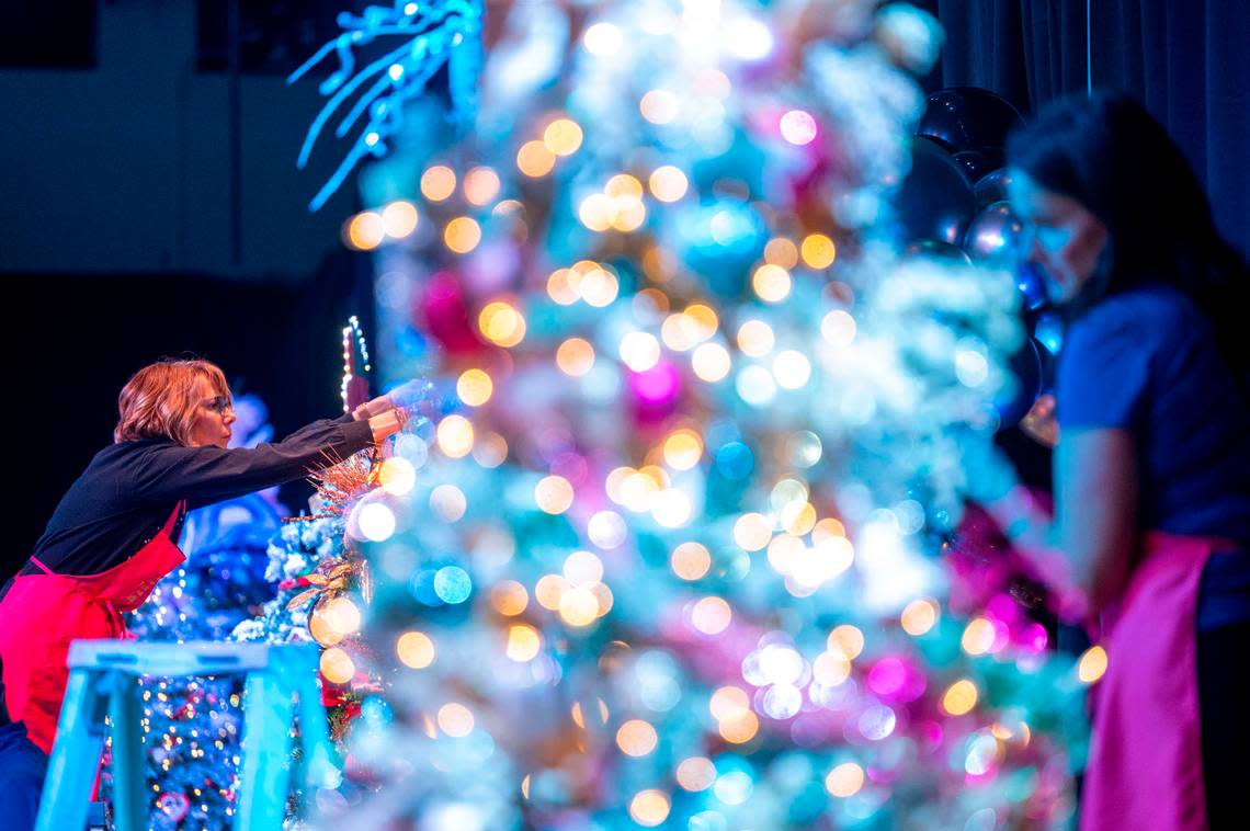 Tammy Hall (left) and Kimberly Golob (right) put the finishing touches on their respective trees during decorating day at the Mary Bridge Children’s Festival of Trees on Tuesday, Nov. 29, 2022, at the Tacoma Armory in Tacoma. Pete Caster/Pete Caster / The News Tribune