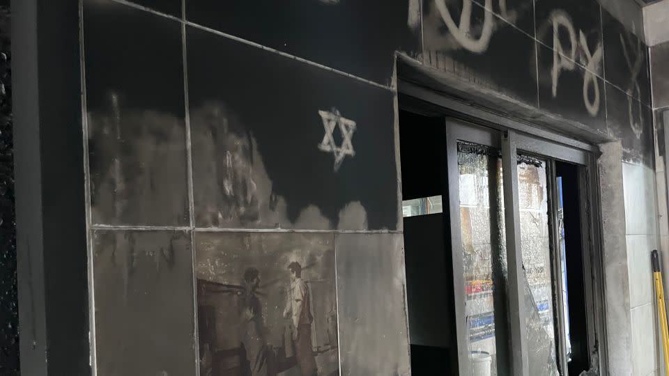 Soot still clings to the walls of the dairy farm that Stevie Marcus manages, several weeks after Hamas fighters raided the settlement and set buildings alight. - Joseph Ataman/CNN