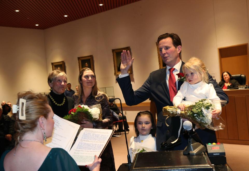 Deaglan McEachern is sworn in for a second term as mayor of Portsmouth at City Hall Tuesday, Jan. 2, 2024. His mother, Shaun, wife Lori and their two children Tiernan and Aurelia stand with him.