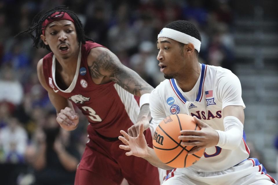 Kansas' Dajuan Harris Jr. grabs a loose ball in front of Arkansas' Nick Smith Jr. during the first half of a second-round college basketball game in the NCAA Tournament Saturday, March 18, 2023, in Des Moines, Iowa. (AP Photo/Morry Gash)