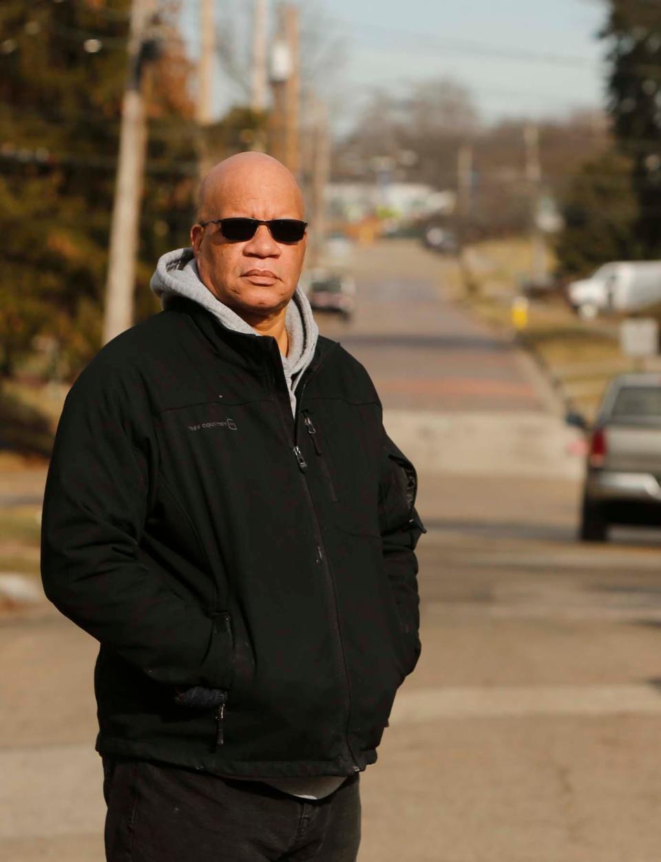 The Rev. Greg Harrison stands on Douglas Street where he grew up and attended an elementary school at the end of the street with his neighbors and friends. The home his family rented was torn down to make way for the Innerbelt. 