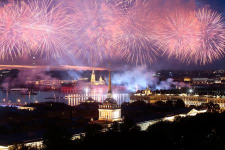 Fireworks are seen over the Admiralty building, the Peter and Paul cathedral and the State Hermitage museum during the festivities marking school graduation in St. Petersburg, Russia June 24, 2018. REUTERS/Anton Vaganov