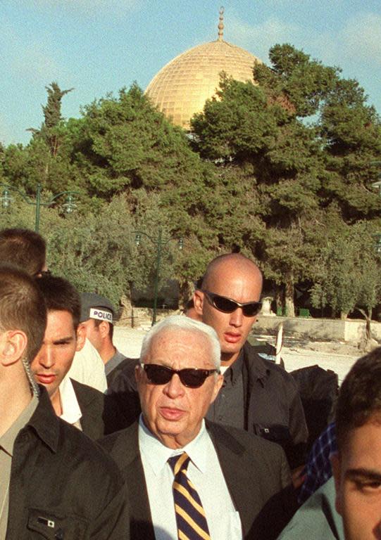Israeli right-wing opposition leader Ariel Sharon (C) is flanked by security guards as he visits the Al-Aqsa mosque compound in Jerusalem's Old City on September 28, 2000