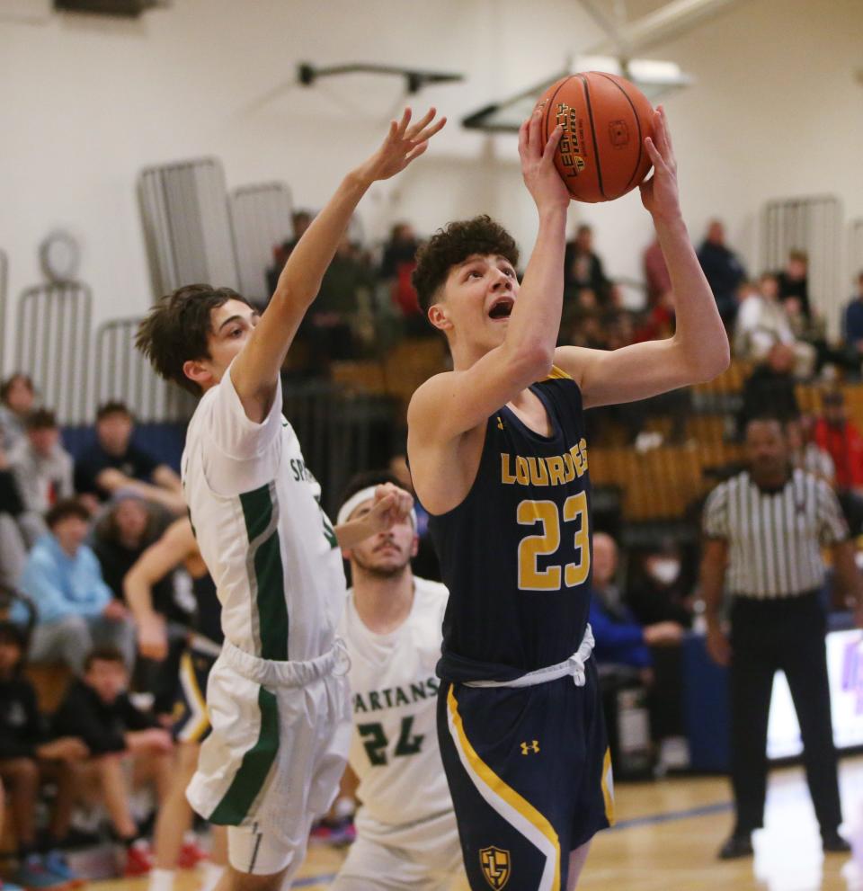 Lourdes' Zach Hart goes for a layup against Spackenkill's Oliver Katz during the MHAL boys basketball final on February 23, 2023. 