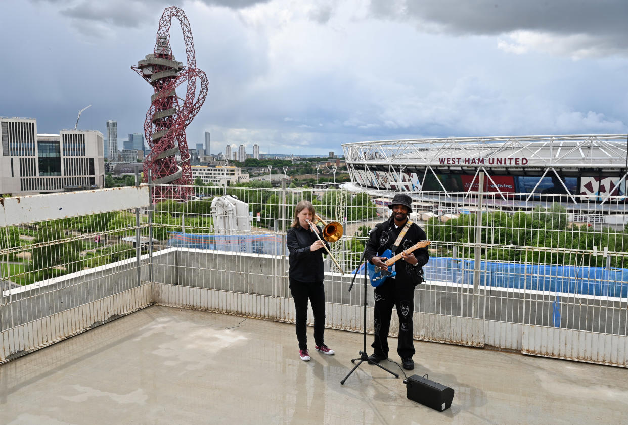 Hak Baker and Helen Vollam celebrate the topping out of the BBC’s new music studios at East Bank, with the first live performance (Mark Allan/BBC/PA)